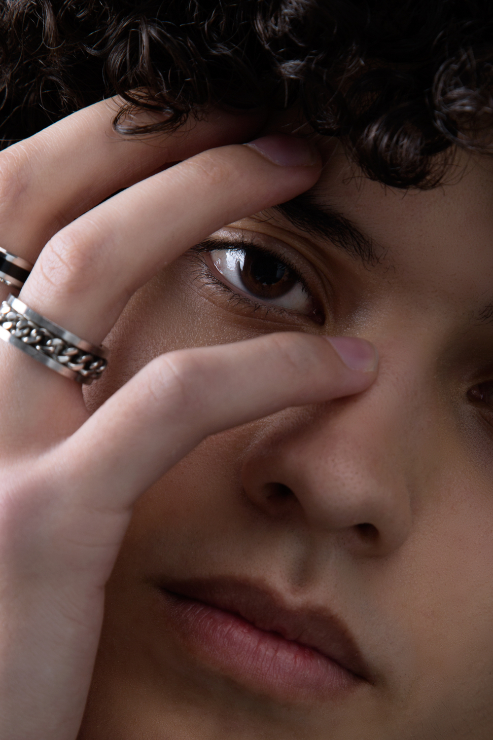 Close eye shot with the hand hiding part of the face