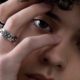 Close eye shot with the hand hiding part of the face